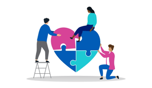 Three people assemble a heart-shaped puzzle together.